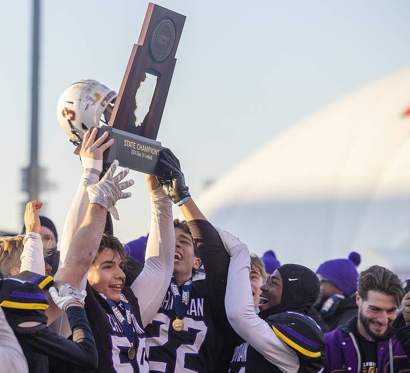 Chicago Christian hoists the first place trophy after besting Maroa-Forsyth 47-0 Friday, Nov. 29, 2024, in the class 2A football state final.