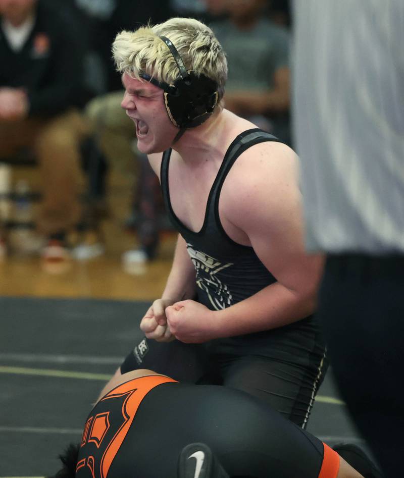 Sycamore’s Adam Carrick celebrates after pinning DeKalb’s Mario Cosme at 215 pounds Friday, Jan. 16, 2026, at Sycamore High School.