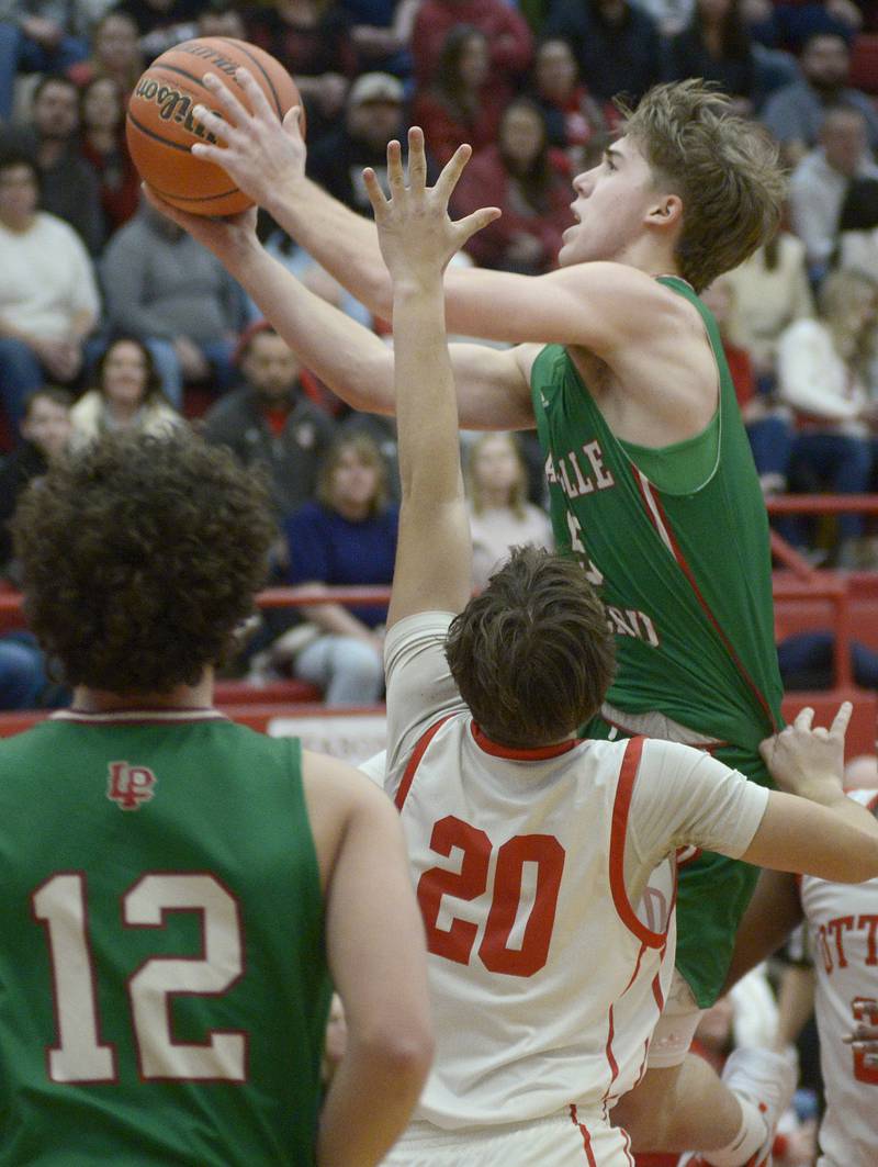 The Cavalier’s Seth Adams gets above Ottawa’s Conner Diederich for a layup in the 2nd period Friday at Ottawa.