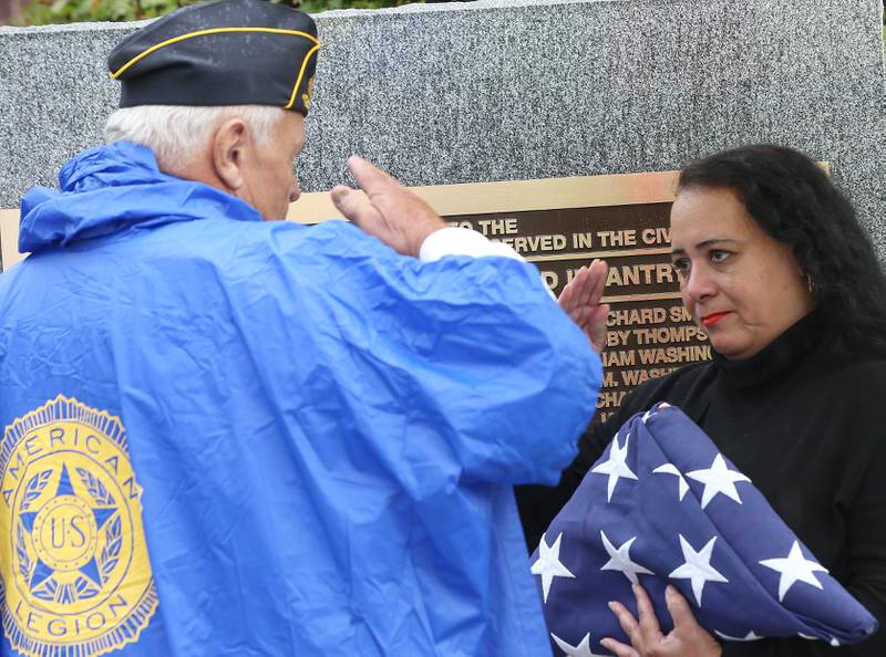 Vern Sondgeroth, Commander of the American Legion Veterans Post #180 hands Francis Clarke, a great-grandaughter of Charles Moses Sr unveil a monment during a Civil War Monument Ceremony on Friday, Sept. 22, 2023 outside the Sash Stalter Matson Building in Princeton. The memorial honors 45 black troops who lived in Bureau County and fought in the Civil War.