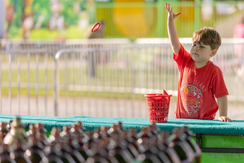Beckham Dagenais, 3, participates in the ring toss game at the Tri County Fair on August 30, 2025 in Mendota.