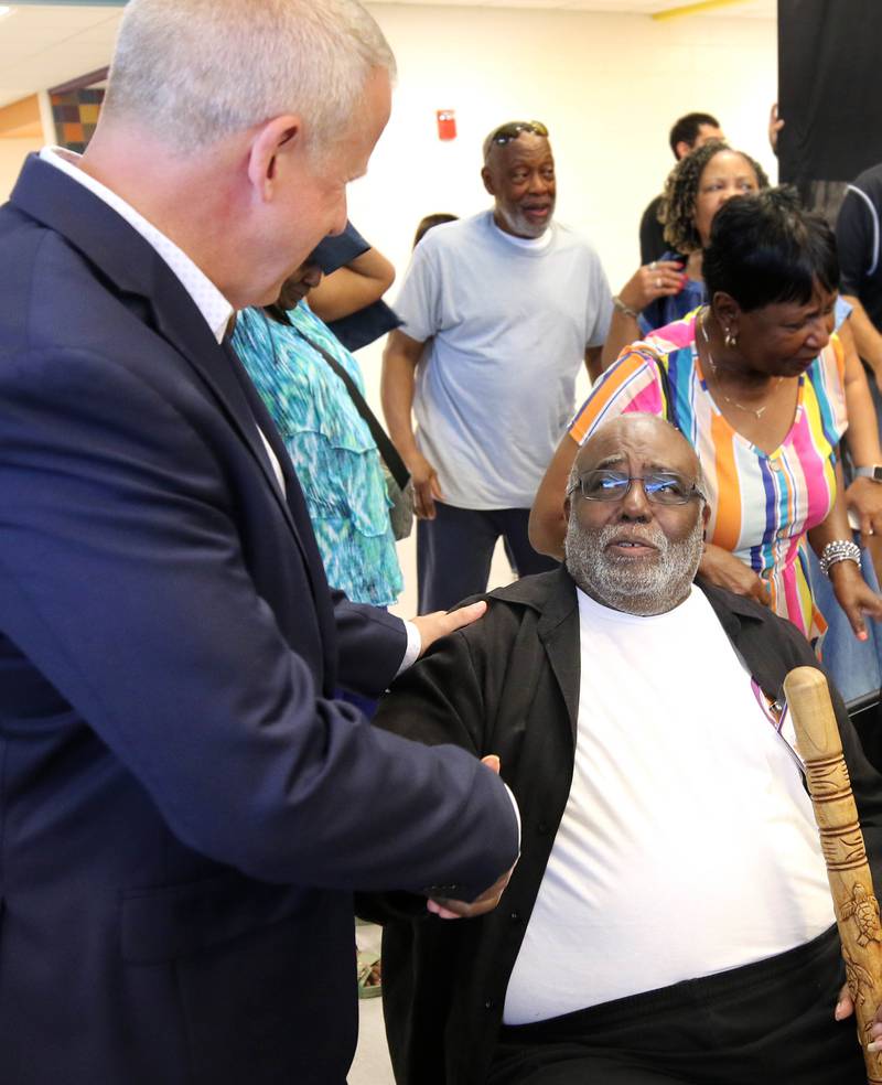 DeKalb Mayor Cohen Barnes (left) congratulates Leroy Mitchell Friday, Aug. 8, 2025, following the grand opening celebration for the school that bears his name, Dr. Leroy A. Mitchell Elementary School in DeKalb.