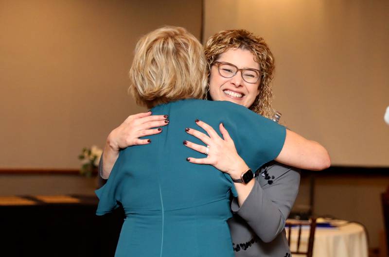 Susi Brucato of Scentcerely Yours (right) hugs Geneva Chamber of Commerce Membership Director Robyn Chione after Susi and her husband, Rob, were named Members of the Year by the Geneva Chamber of Commerce during the chamber’s annual dinner and award night at Riverside Receptions on Wednesday, Nov. 16, 2022.