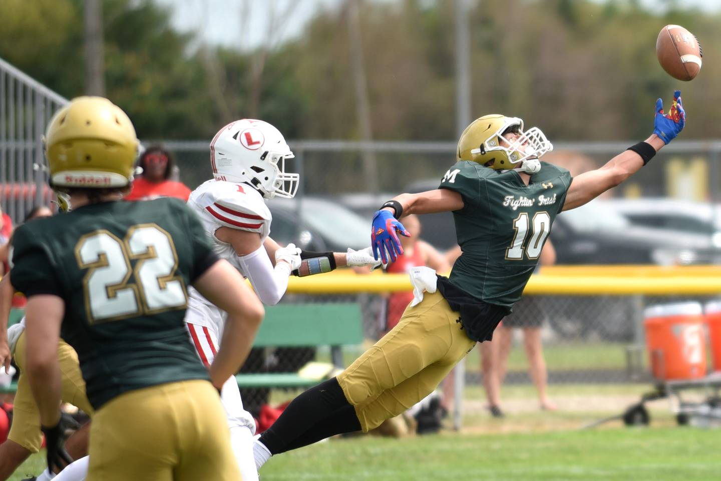 Bishop McNamara's Coen Demack, right, extends in attempt to intercept a pass during the Fightin' Irish's home game against Lawrenceville Saturday, Aug. 30, 2025.