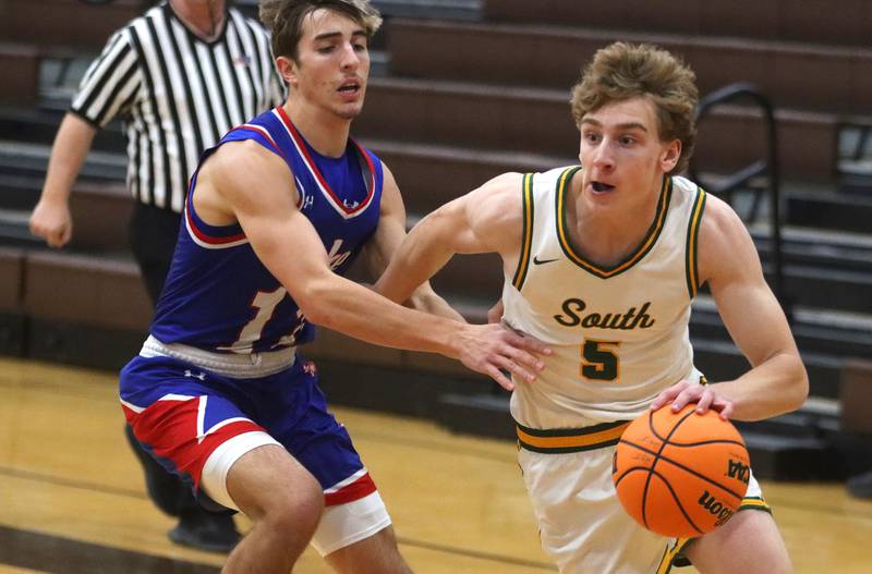 Crystal Lake South’s Carson Trivellini, right, drives on  Lakes’ Aidan Hopkins in varsity boys basketball Hinkle Holiday Classic action on Friday, Dec. 26, 2025, at Jacobs High School in Algonquin.