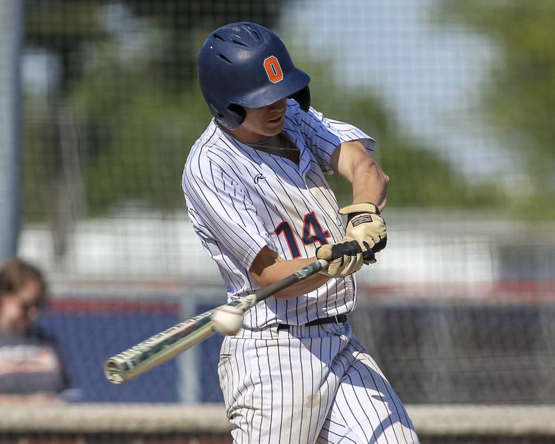 Oswego's Caleb Miller (14) connects on a pitch during baseball game Oswego East at Oswego.  May 14, 2026 in Oswego.