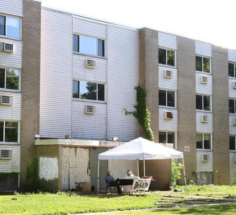File photo - A City of DeKalb tent is set up in front of the old Edgebrook Manor Apartment Complex at 912 Edgebrook Drive last June in DeKalb. The city then was asking nearby residents for their input as to what to do with the property after it is demolished. The building has sat vacant since 2014 after it was condemned for major structural issues.