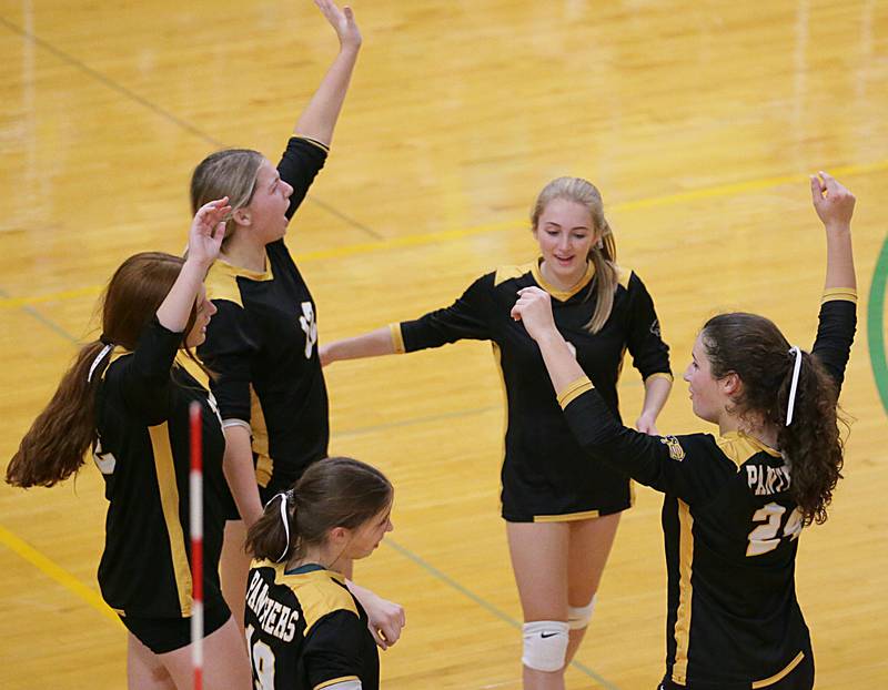 Members of the Putnam County volleyball team celebrate after defeating Henry in the Tri-County Conference Tournament on Monday, Oct. 10, 2022 in Seneca.