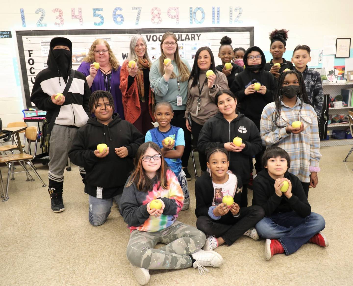 Woodland Elementary fourth-grade teacher Chelsea Young (center) was recently named a 2023 Golden Apple Awards for Excellence in Teaching finalist. Her students received golden delicious apples so they could celebrate with her.