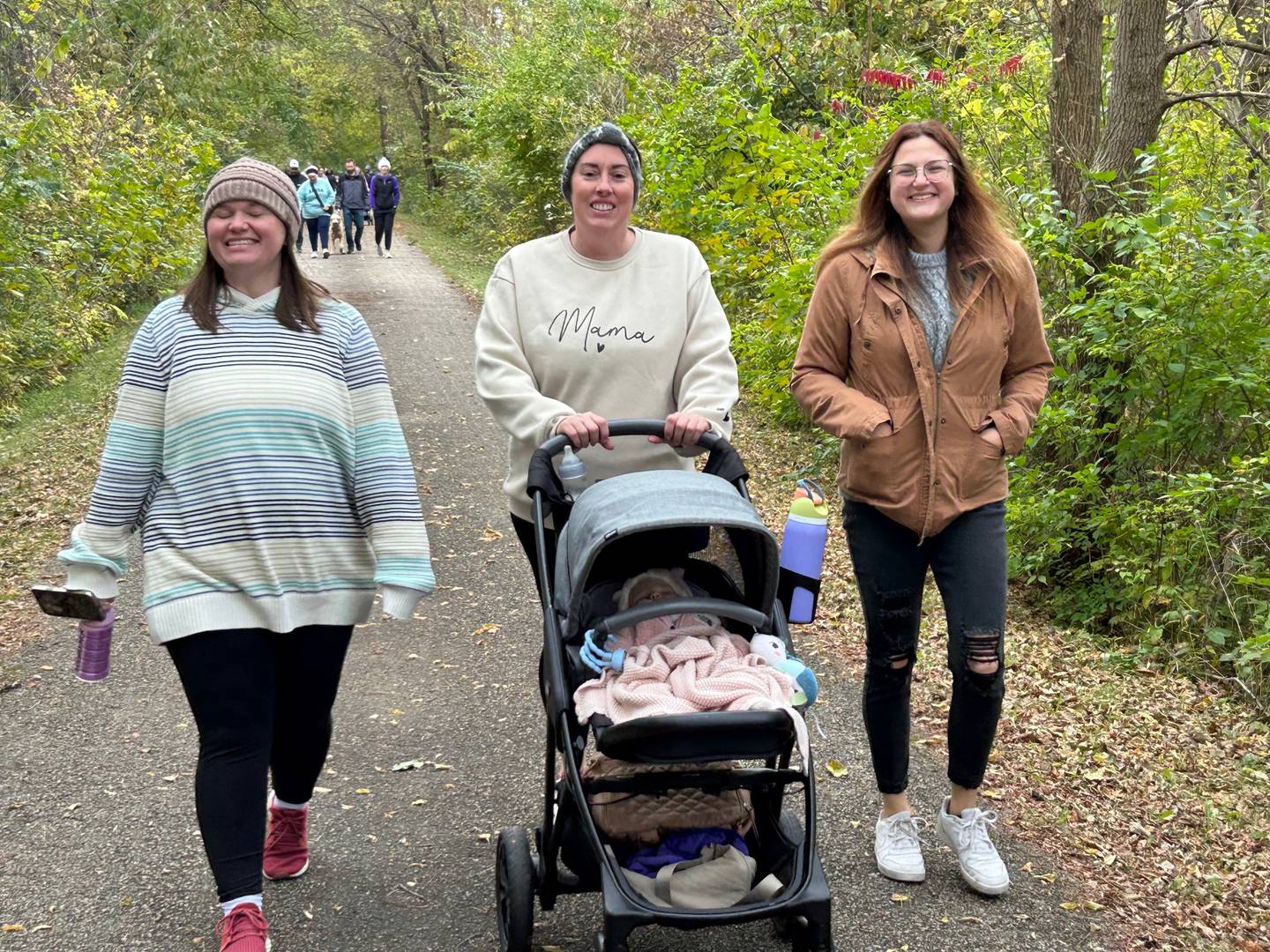 Macy Mikan, Brooke Jones with passenger and Madison Coulter take a stroll during the Nourish the Journey 5K run/walk event Saturday, Oct. 25 on the Dixon bike path.