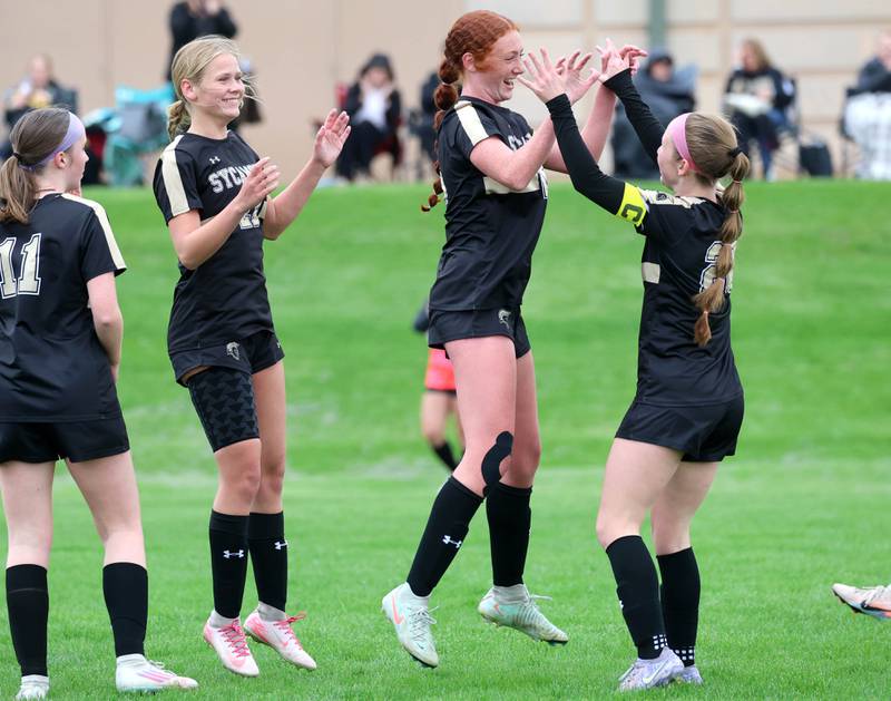 Sycamore's Isabelle Segreti (middle) celebrates with teammates after scoring a goal during their game against Kaneland Wednesday, April 29, 2026, at Sycamore High School.