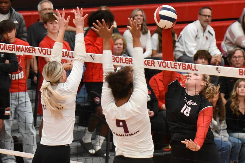 Bradley-Bourbonnais' Elena Shold, right, looks to send a hit past Champaign Central's Hayden Curtis, left, and Iy'Jah Grant during a game at Bradley-Bourbonnais Thursday, Oct. 23, 2025.