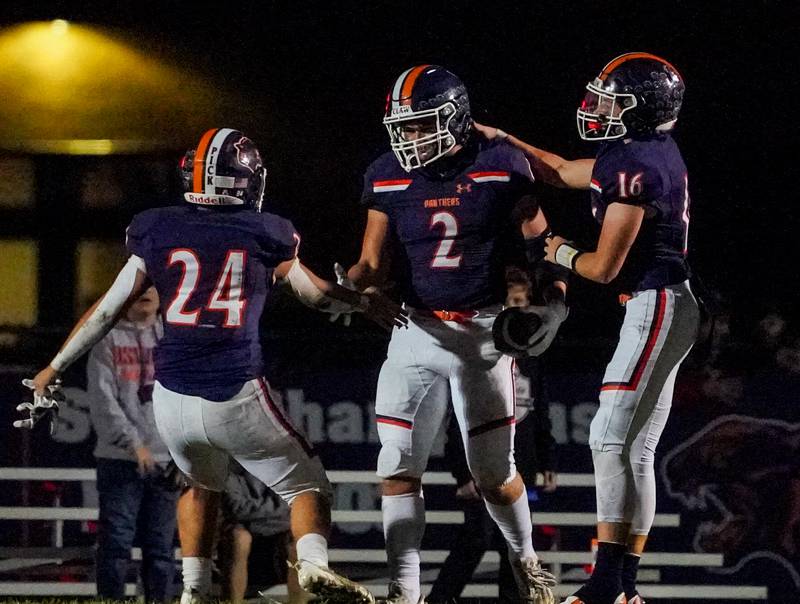 Oswego’s Lucas Andersen (2) celebrates with Oswego’s Ayden Villa (24) and Oswego’s Brett Connolly (16) after scoring a touchdown against West Aurora during a football game at Oswego High School on Friday, Sept. 29, 2023.