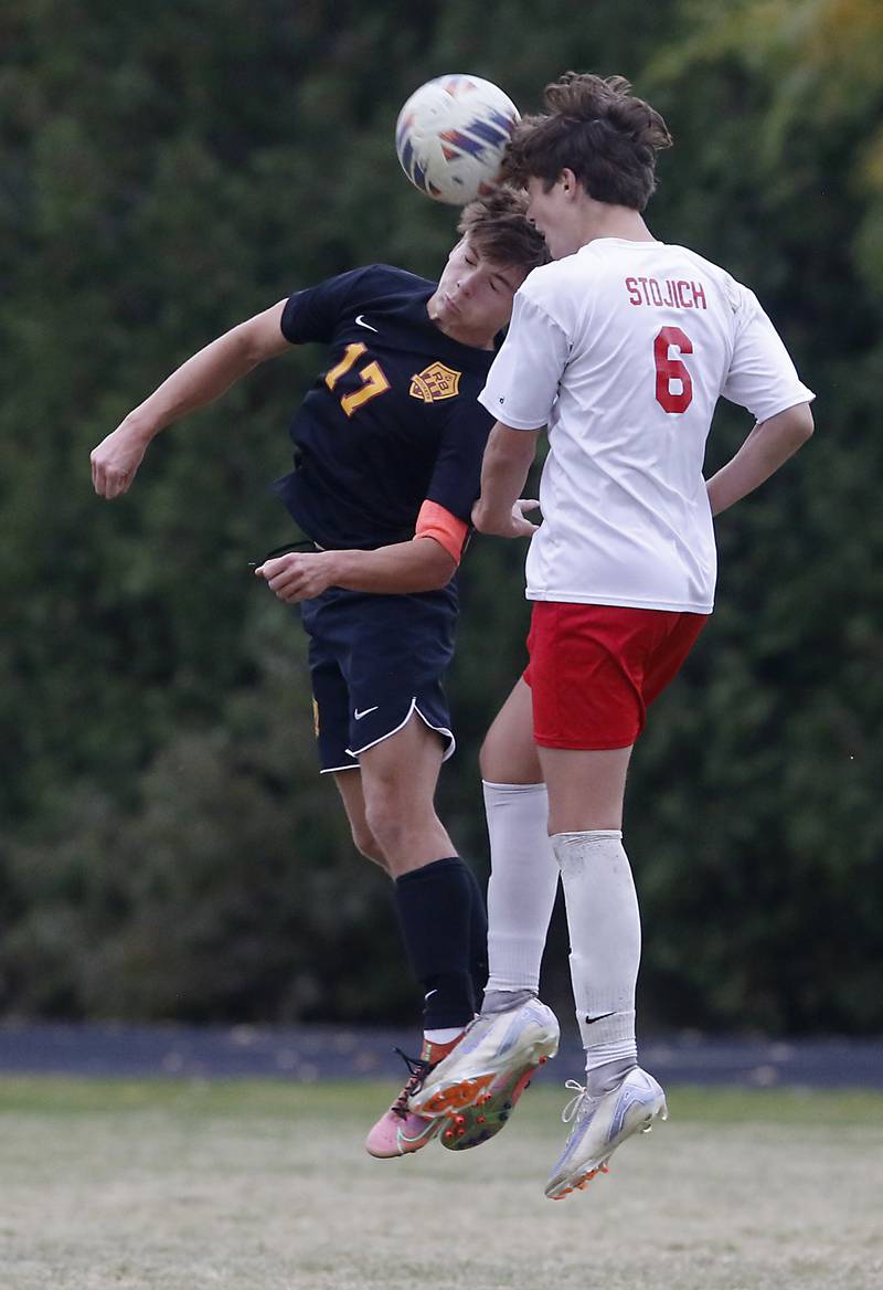 Richmond-Burton's Joseph Kyes heads the ball away from Marian Central's Stefan Stojich during the IHSA Class 1A Marian Central Regional Boys Soccer Final match on Tuesday, Oct. 22, 2024, at Marian Central High School in Woodstock.