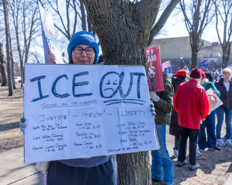 Protester holds sign at the 'Pretti good time for a Protest' on Feb. 15, 2026 at Washington Square Park in Ottawa.