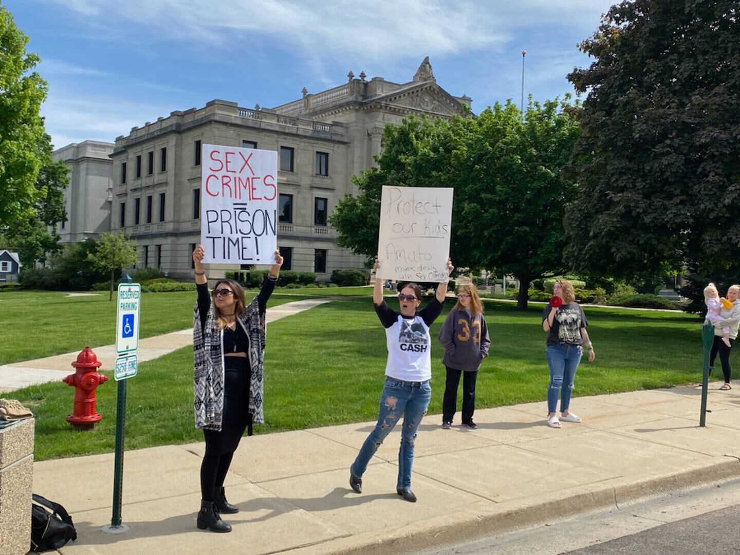 A handful of women gathered along Main Street outside the DeKalb County Courthouse in Sycamore Monday, May 15, 2023. The women expressed solidarity for Gracie Sasso-Cleveland, 15,  a slain DeKalb High School freshman who's death is at the center of murder charges for 29-year-old Timothy M. Doll, of DeKalb, a registered sex offender. The women called for stricter Illinois laws against sex offenders.