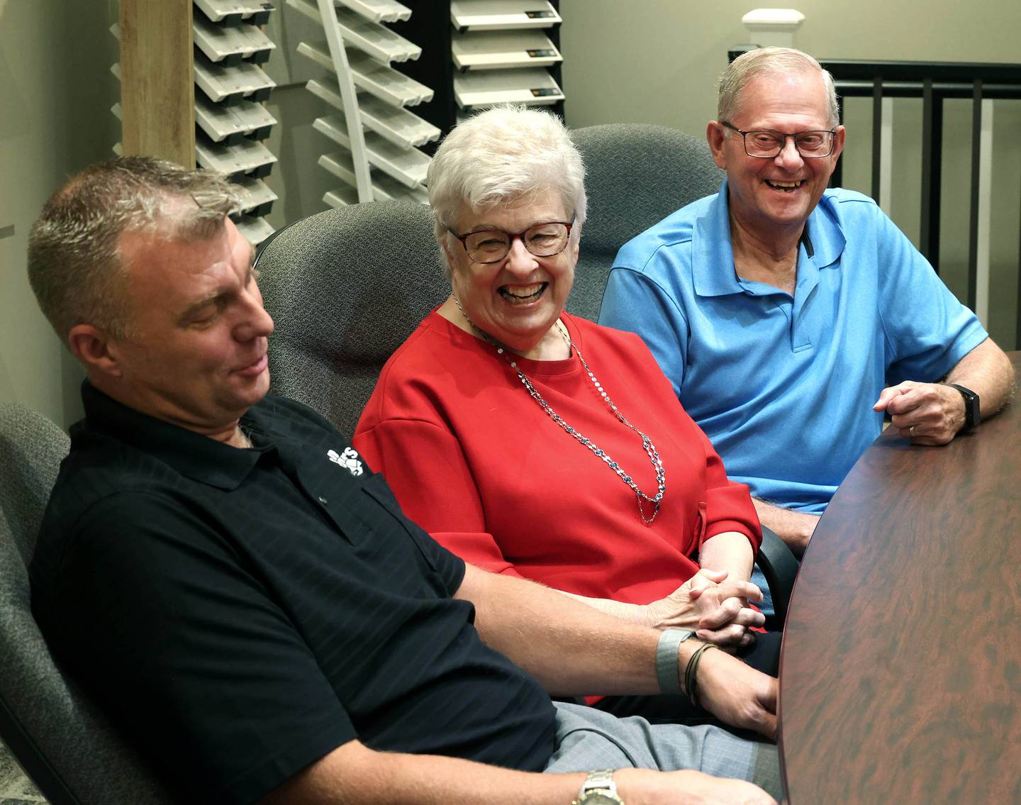 Greg Spears, (left) Ken Spears Construction president, and his parents and company founders, Ken and Kathy Spears have a laugh when talking about working with family Friday, Aug 22, 2025, at the business in DeKalb. The company is celebrating its 50th anniversary this year.
