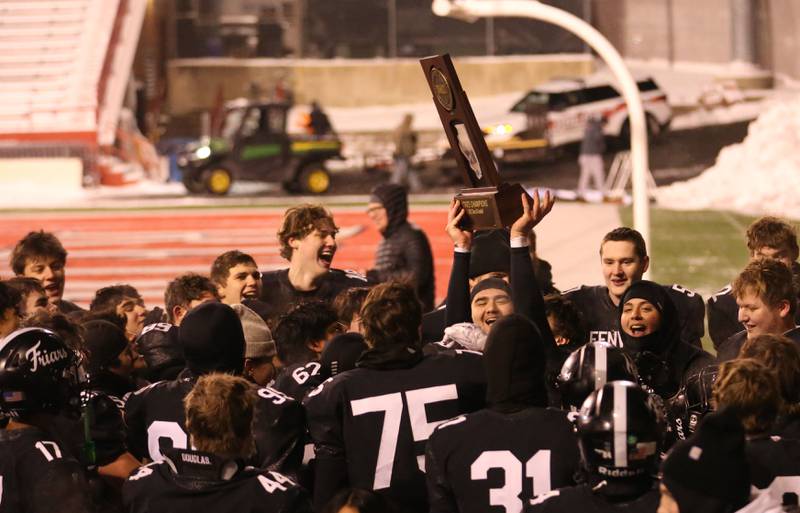 Members of the Fenwick football team hoist the Class 6A State championship trophy on Tuesday, Dec. 2, 2025 in Hancock Stadium at Illinois State University in Normal.