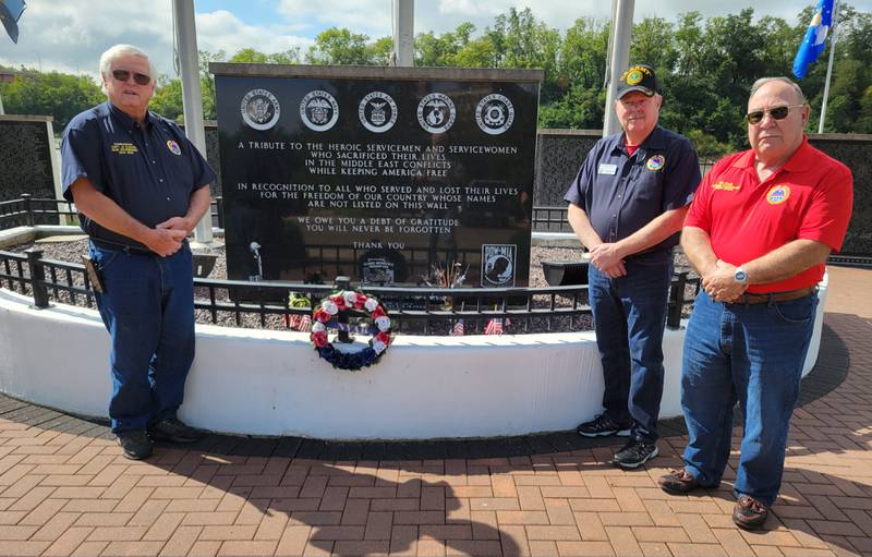 AMVETS National Commander Bill Clark (right), Illinois Commander Steven Holt (second from right) and past Illinois Commander Robert Stuebinger pause in front of the Middle East Conflicts Memorial Wall in Marseilles on Tuesday.