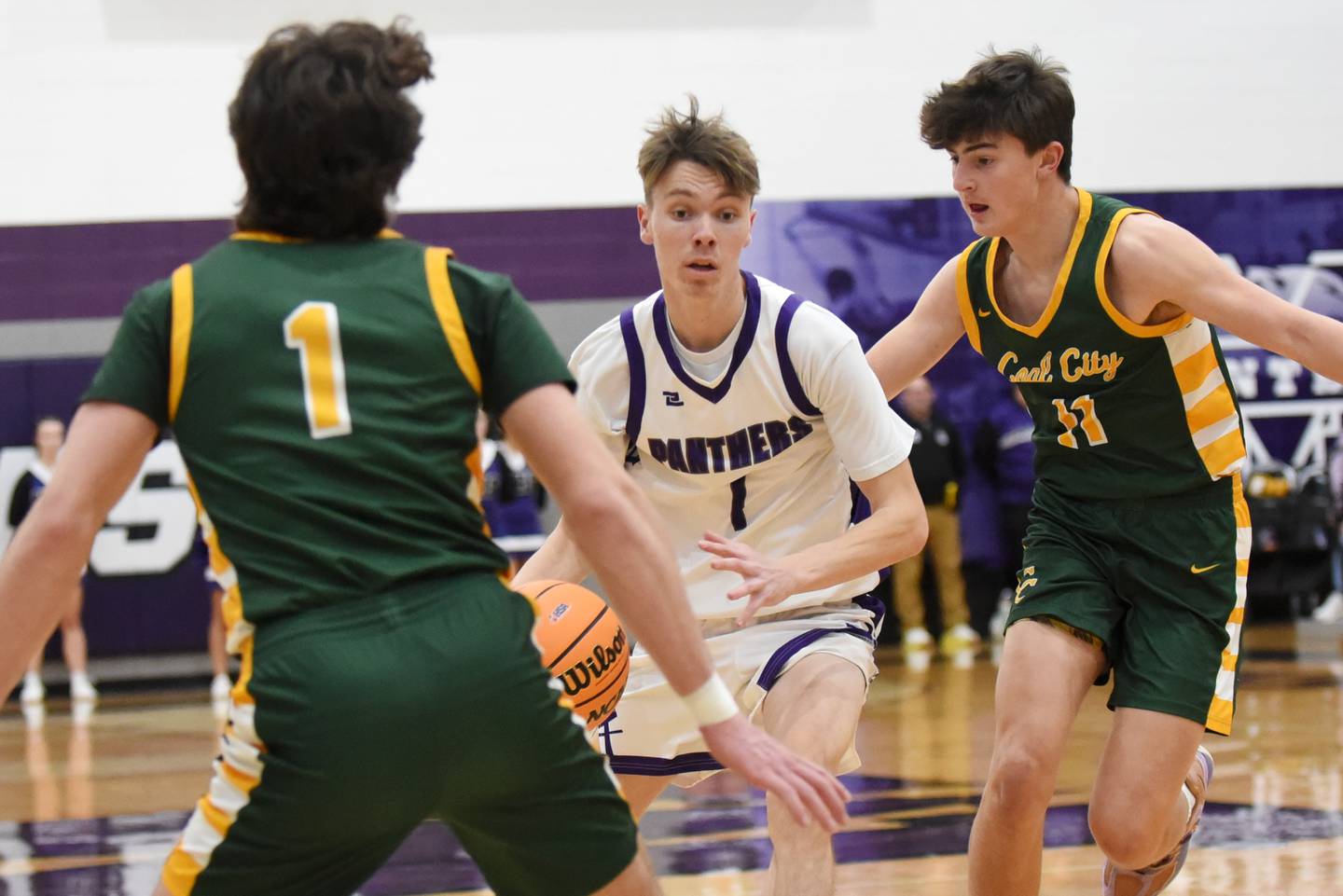 Manteno's Eric Eldridge, center, drives between Coal City's Gavin Berger, left, and Connor Henline during the IHSA Class 2A Manteno Regional quarterfinals Monday, Feb. 23, 2026.