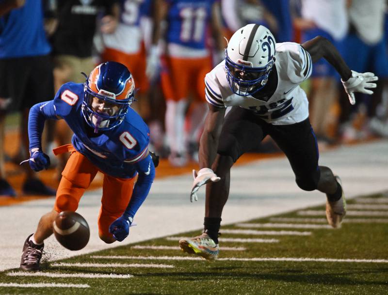 Hoffman Estates’ Javon Leach recovers a kickoff fumbled by Maine East’s Samuel Oppong during Friday’s football game in Hoffman Estates.