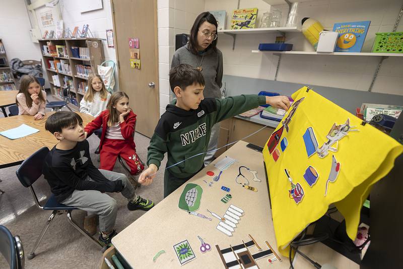 Zion, a Jefferson School second grader, picks out an important pet care item to place on a board Thursday, Feb. 5, 2026. Granny Rose Assistant Director Kalena Dixon is helping educate students on pet care.