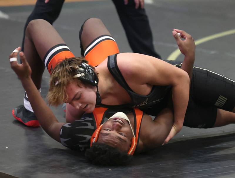 Sycamore’s Peter Gehrig tries to pin DeKalb’s Darius Russell during their 190 pound match Friday, Jan. 16, 2026, at Sycamore High School.