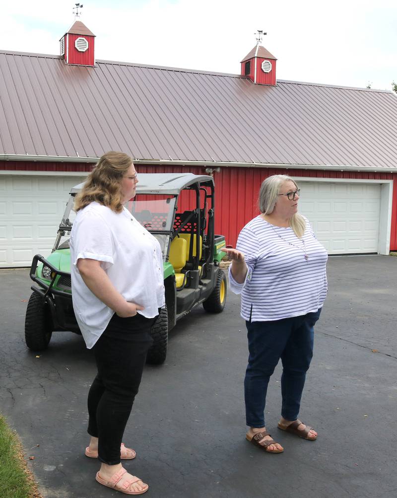 Tammy McMahan, (right) founder and executive director of the Ruth Project, along with her daughter Ashley, storehouse manager with the group, talk Thursday, July 13, 2023, at the organization’s 33-acre farm in Sycamore. The Ruth Project is a group based in Elgin that provides support for foster parents and children.