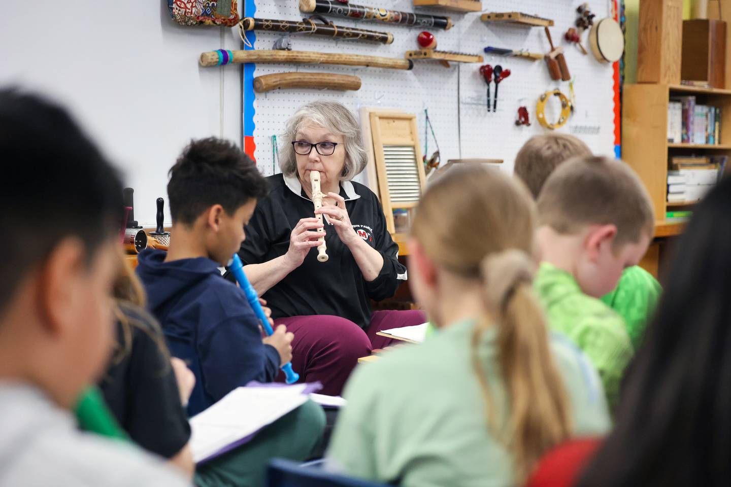 Pat Gordon, music teacher at Momence's JeNeir Elementary School, plays along with her students during class on April 17.