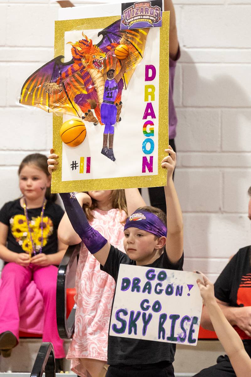 Child holds sign on Wednesday, April 16, 2025 at Woodland High School in Woodland.