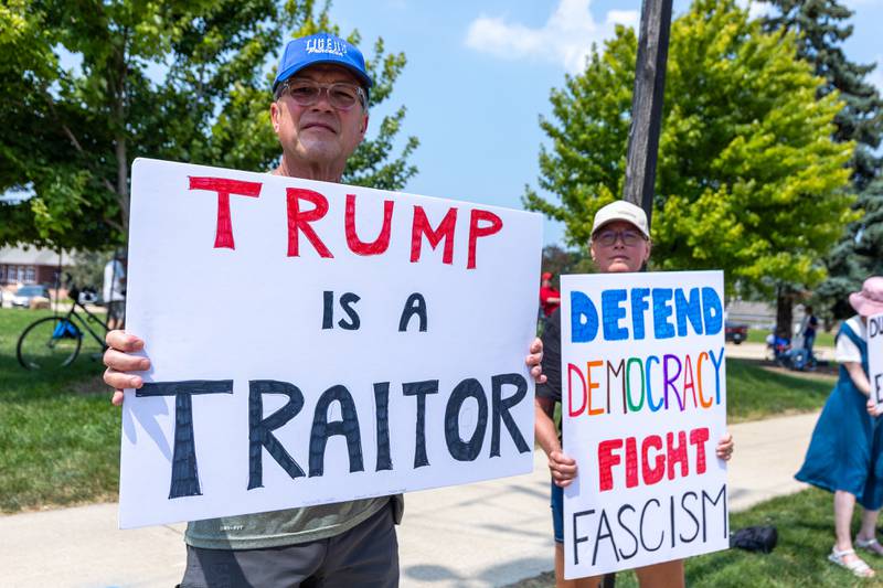 Protesters hold signs at the “No Kings” protest on Saturday,  August 9, 2025 at Rotary Park in Princeton.