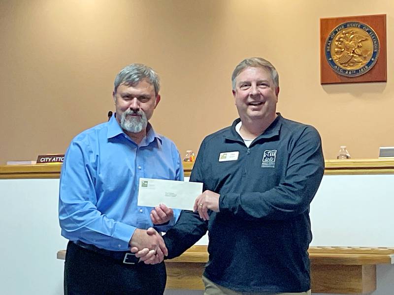 Sandwich Mayor Todd Latham accepts an economic development implementation grant from Community Foundation Executive Director Dan Templin.