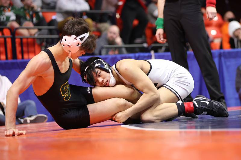 Plainfield North’s Jacob Macatangy gets two points by dropping Stevenson’s Lorenzo Frezza in the Class 3A 126lb. 3rd place match at State Farm Center in Champaign. Saturday, Feb. 19, 2022, in Champaign.