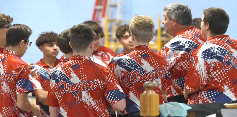 Oregon High School bowling coaches Al and AJ Nordman (right) talk to their team before the start of a match with Harvard at Town & Country Lanes in Mt. Morris on Friday, Dec. 19, 2025.