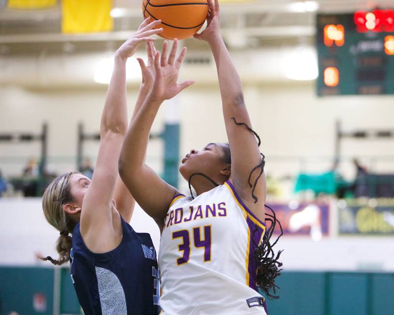 Downers Grove North's Elizabeth Murphy puts the shot up over Nazareth's Stella Sakalas during the Dave Yates Chicagoland Showcase on Saturday, Dec7,2024 at Fremd in Palatine.