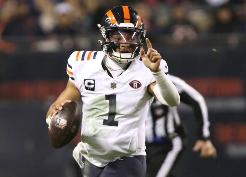 Chicago Bears quarterback Justin Fields directs traffic as he scrambles in the fourth quarter of their game against the Arizona Cardinals Sunday, Dec. 24, 2023, at Soldier Field in Chicago.