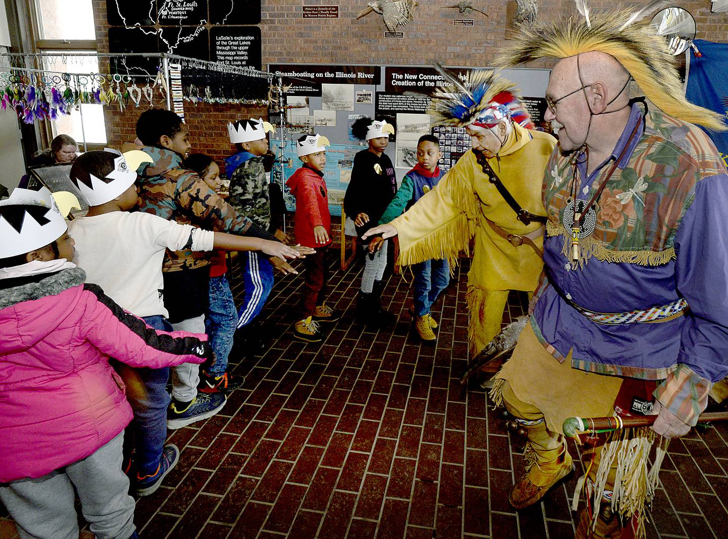 Scouts join in a Native American dance with members of the Kickapoo tribe Saturday, Jan. 28, 2023, at the Illinois Waterway Visitors Center as part of the Eagle Watch Weekend.