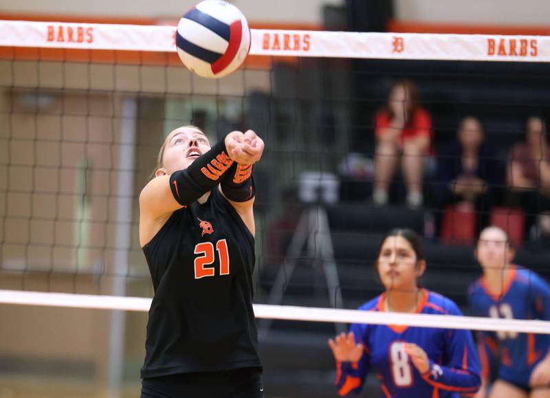 DeKalb's Maddi Hollar bumps the ball back towards the net during their match against Genoa-Kingston Wednesday, Sept. 10, 2025, at DeKalb High School.