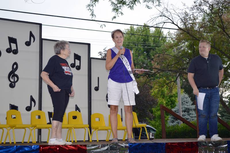 Cathy Krusey, of German Valley, was selected as the village's 2022 Most Valuable Person. Here, Krusey, center, speaks after being announced as the MVP at German Valley Days on July 16 at Ben Miller Park. To her left is German Valley Days organizer Donna Smith; to the right is emcee Colin Rust.