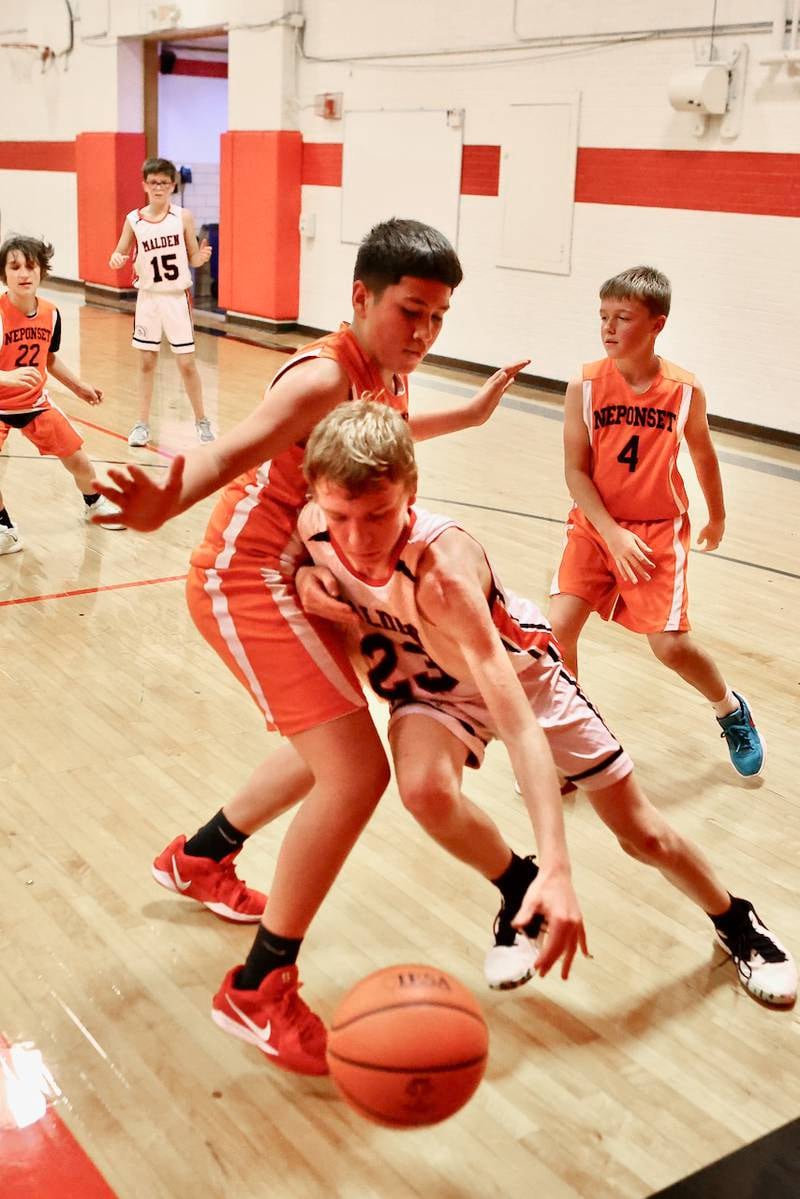 Malden's Aidan Rossler drives against Neponset in Wednesday's game at the Malden Tournament.