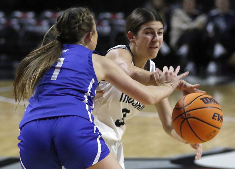 Cary-Grove's Kennedy Manning passes to a teammate as she is guarded by Burlington Central's Kelsey Covey during a Fox Valley Conference basketball game  on Tuesday, Jan. 14, 2025, at Now Arena in Hoffman Estates.