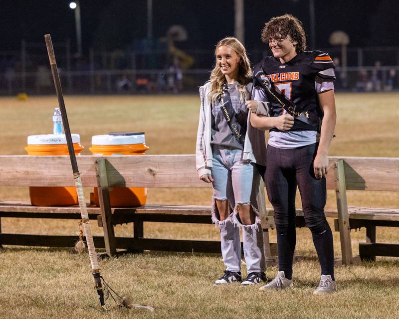 Sydney Wright and Leelynd Durbin stand behind trident after being chosen as homecoming royalty during halftime of game on Friday, Sept. 26, 2025, at Woodland School in rural Streator.