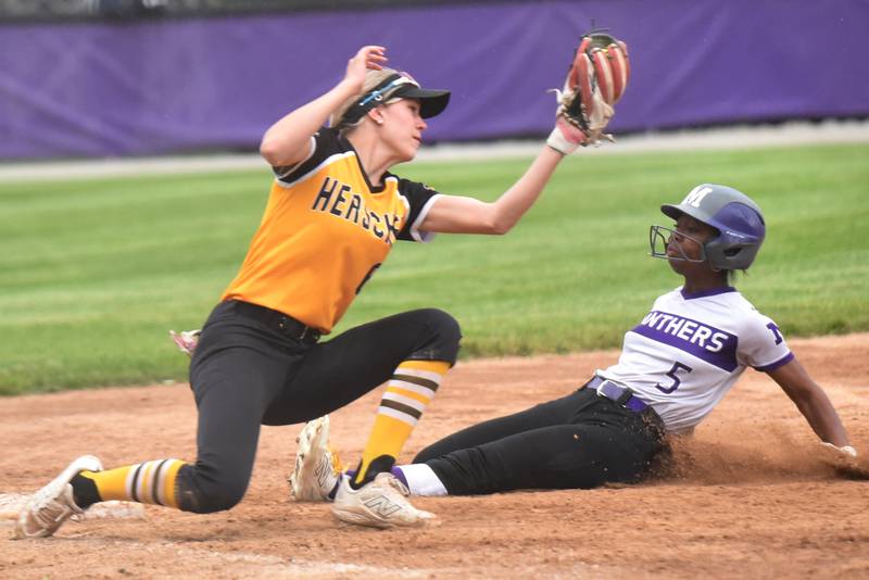 Herscher's Lexi Crawford, left, looks to make a tag as Manteno's Amiya Carlile slides in with a stolen base at third during a game at Manteno Tuesday, May 12, 2026.