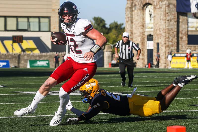 NIU quarterback Rocky Lombardi scrambles for yardage against Toledo on Saturday, Sept. 30, 2023 at the Glass Bowl.