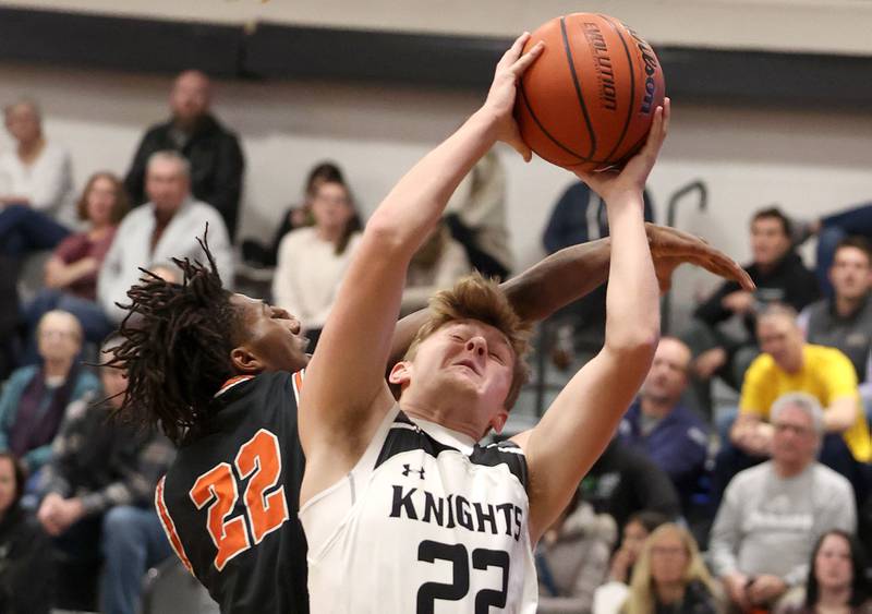 Kaneland's Johnny Spallasso is fouled by DeKalb's Darrell Island as he goes to the basket during their game Tuesday, Jan. 24, 2023, at Kaneland High School.