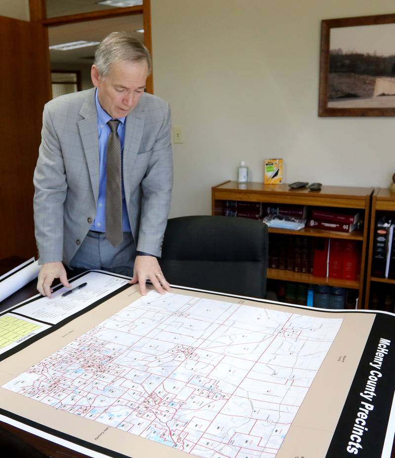 McHenry County board member Joe Gottemoller shows a current map of McHenry County voter districts and precincts on Friday, April 30, 2021 in Crystal Lake. The county is considering redistricting and is awaiting updated census information.