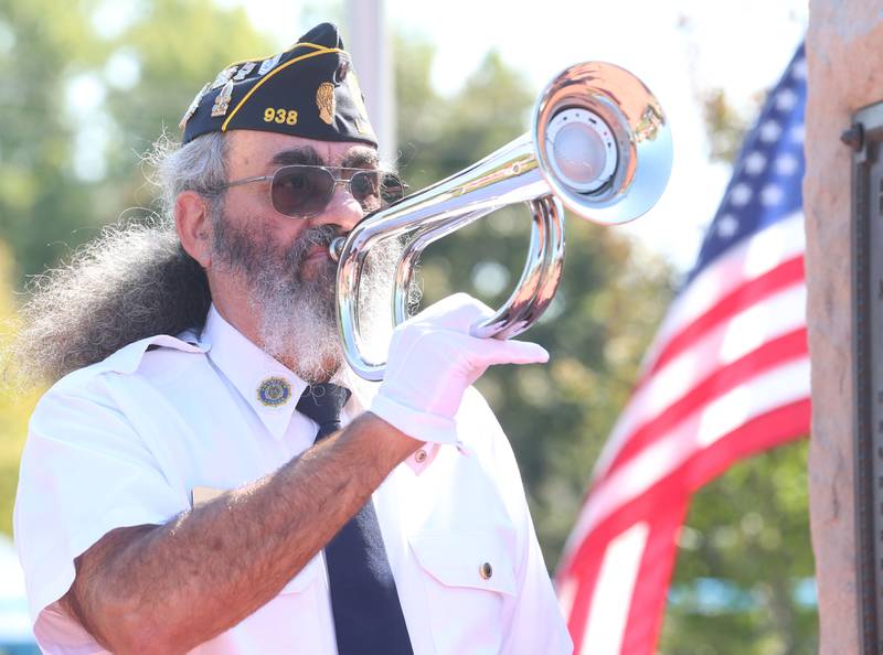 Andy Ruggerio, holds a audio trumpet that plays Taps during during a 9/11 memorial ceremony on Thursday, Sept. 11, 2025 at the Veterans Park in Ladd.