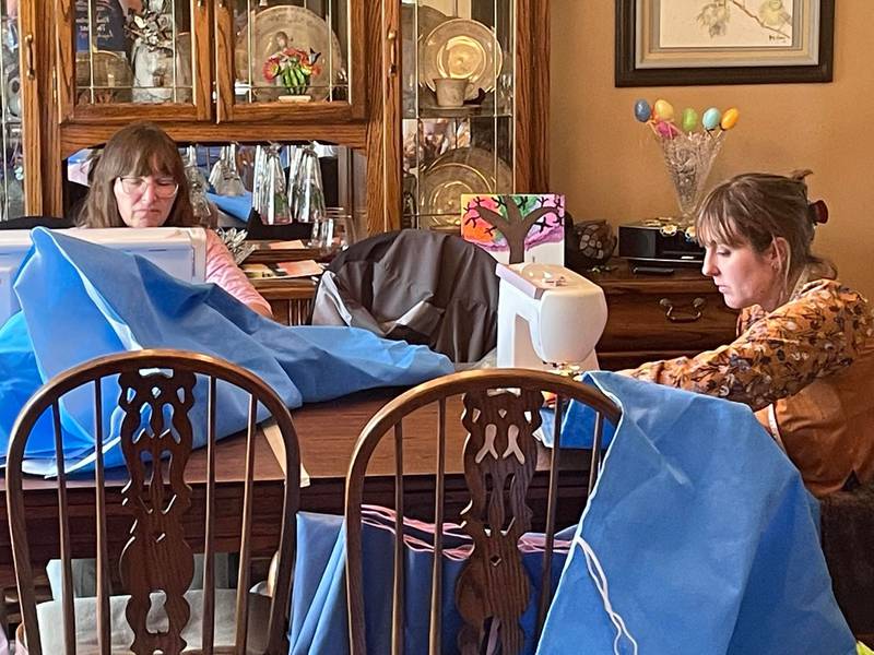 On Saturday, April 9, 2022, a small group of friends gathered at Kimberly Creasey's home in Joliet to create waterproof sleeping bags out of expired surgical drapes. The sleeping bags were sent to Poland, where they will be distributed to people from Ukraine in need. Pictured, from left, are Nancy Waszak and Kayla Motto.