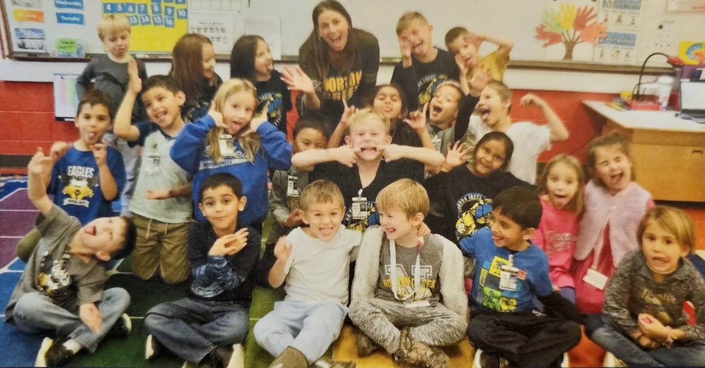 St. Charles School District 303 teacher and reading specialist Amy Kappele poses with a class of elementary school students.