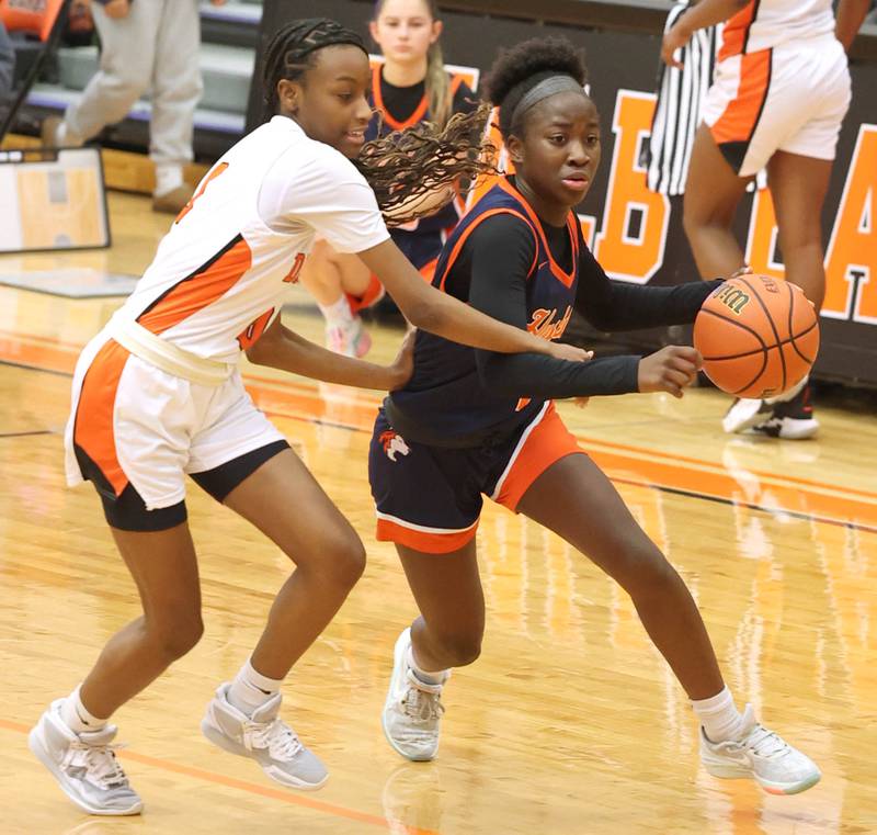 Naperville North's Natalie Frempong drives by DeKalb’s Precious French Monday, Jan. 22, 2024, during their game at DeKalb High School.